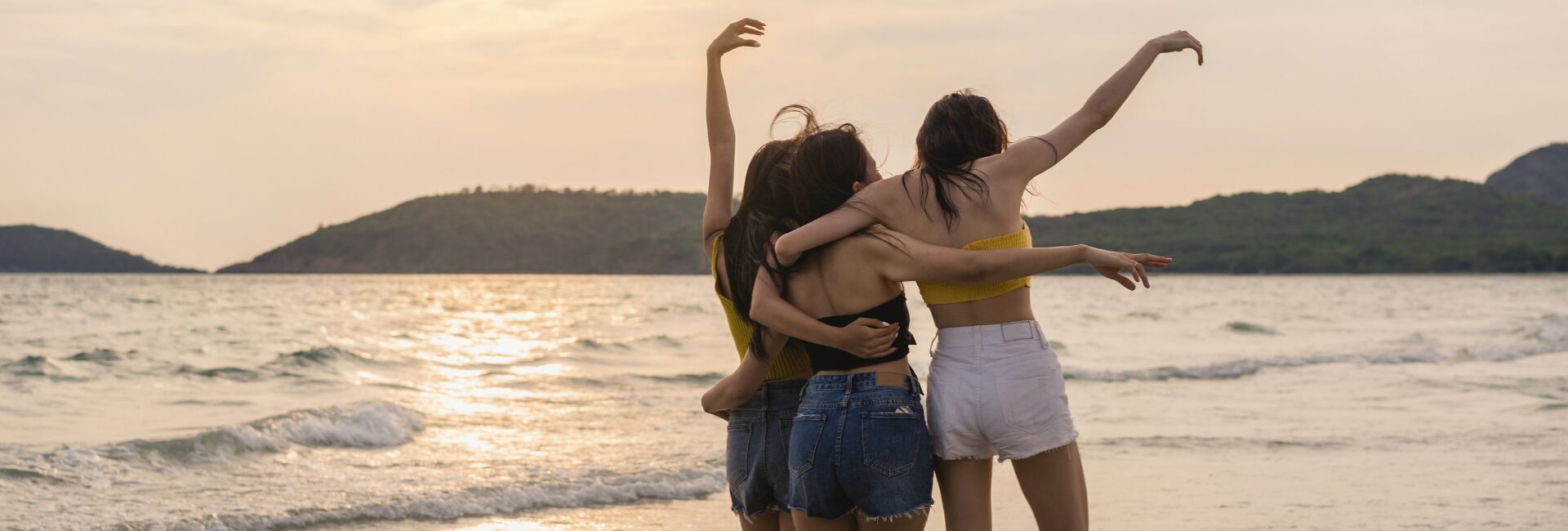 three-friends-enjoying-beach-having-fun-sunset (1)