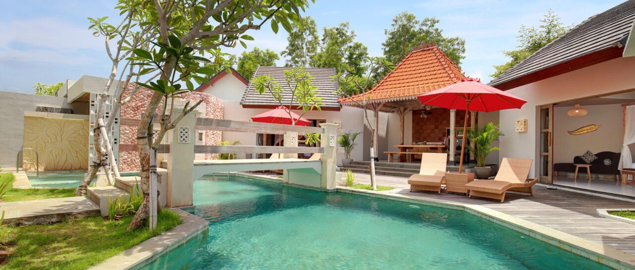 vivara-jimbaran-bali-pool-bridge-red-shade-umbrella